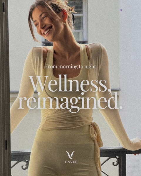 A high-quality lifestyle shot featuring a model in a light yellow wrap top, emphasizing a peaceful morning wellness aesthetic.